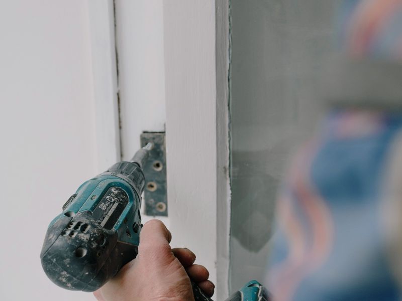 A drill fixing a door hinge