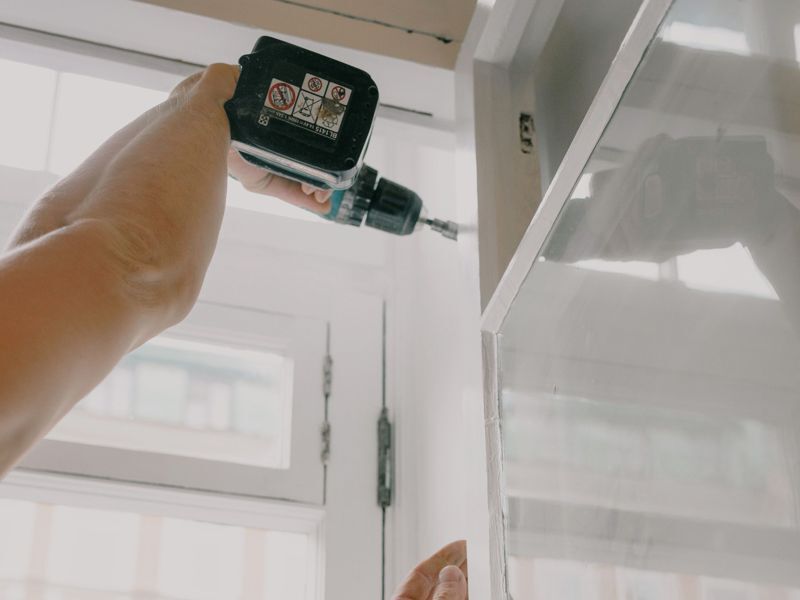A drill fixing a window frame