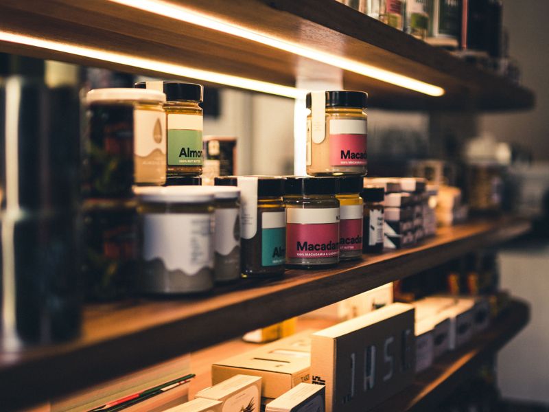Jars of food on a lit shop shelf