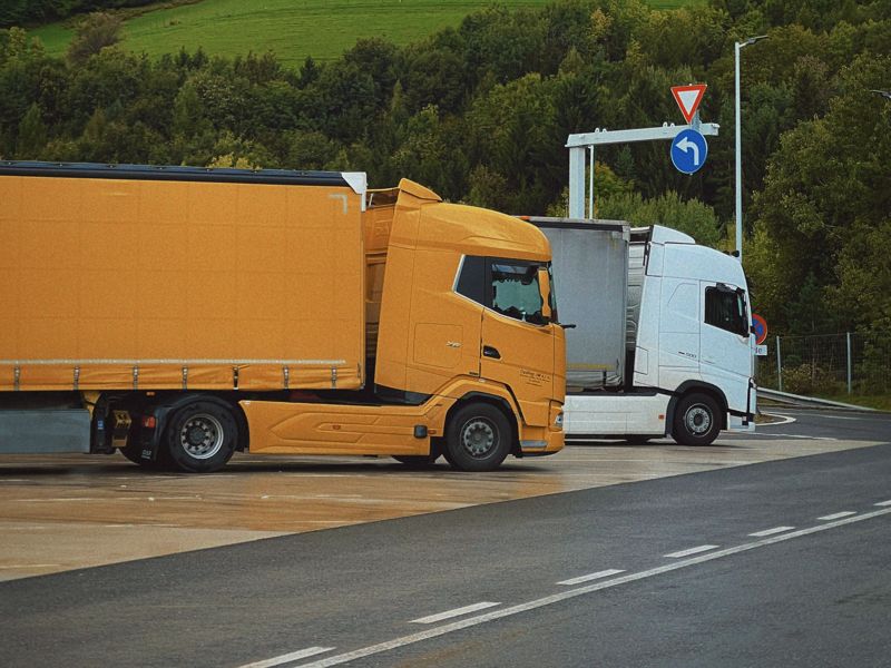 Two trucks at a highway junction