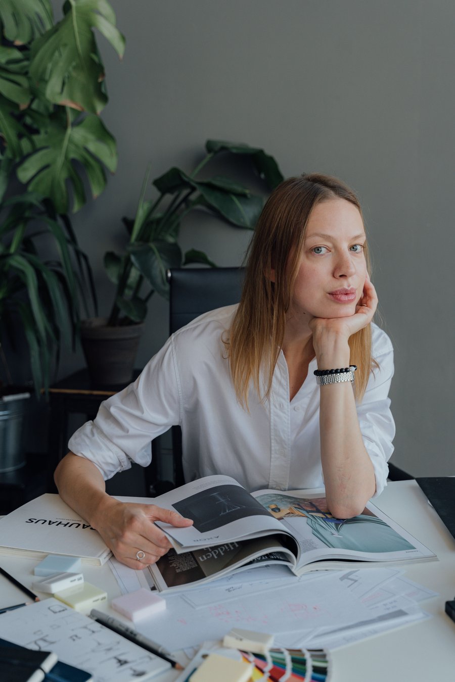 A designer at their desk, thinking