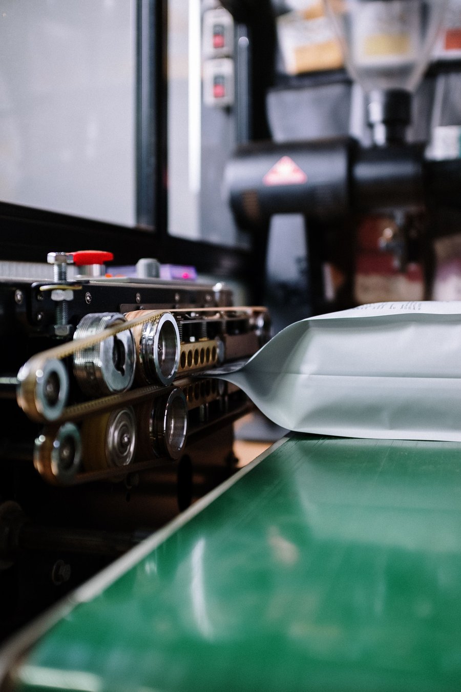 A packaging machine sealing pouches on a production line